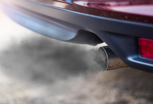 Fototapeta combustion fumes coming out of car exhaust pipe
