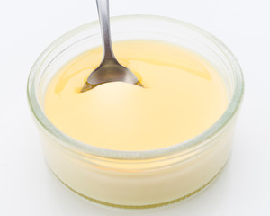 puddle liquid caramel on homemade custard, isolated