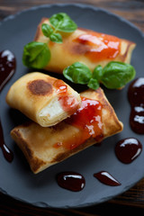 Close-up of crepes with cottage cheese stuffing and jam