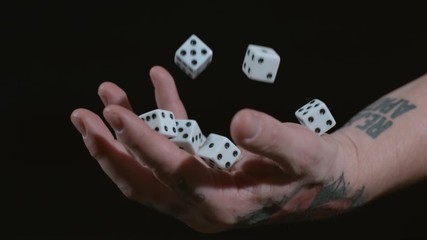 Hand catching dice in slow motion - Powered by Adobe