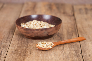 oats in spoon on wood table