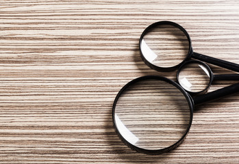magnifying glass on the wooden background