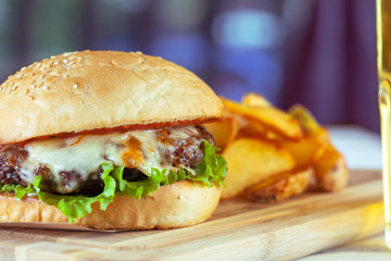 burger and french fries on wooden table