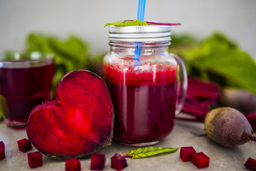 Beetroot juice in a mason jar mug on grey stone background. Detox and healthy diet.