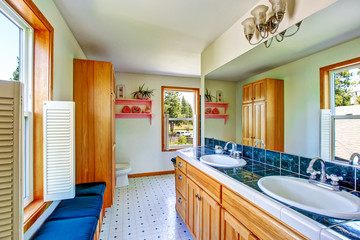 Elegant bathroom interior with blue tile counter top and two sinks