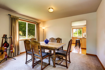 Musician's dining room with carved table set and guitars.