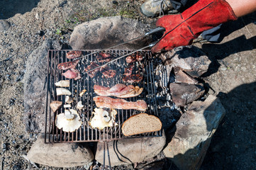 Barbecue with meat, mushrooms and bread