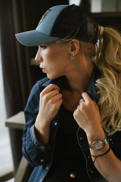 blond girl in a baseball cap.