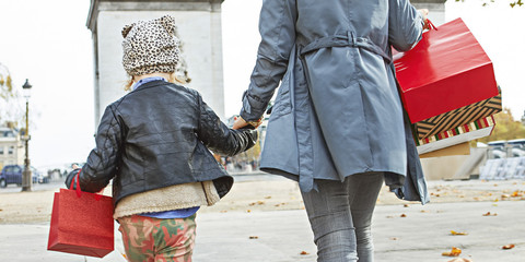 young mother and child shopper in Paris, France walking