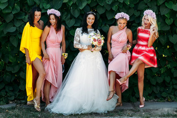 Bride with bridesmaids in the park