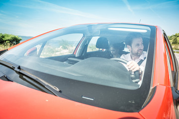 Fototapeta na wymiar Caucasian man driving a car during summer holiday