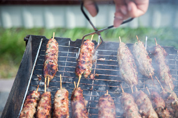 Cooking of lula kebab on the grill at picnic