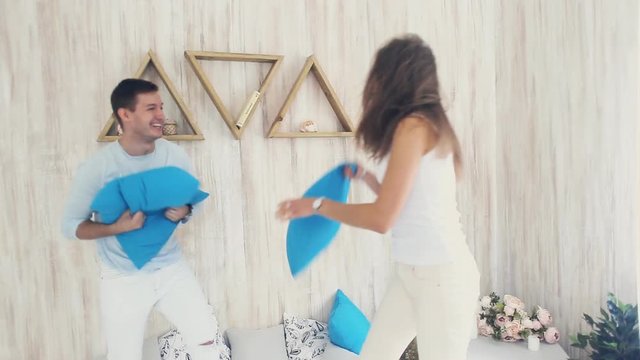 Happy couple in pillow fight