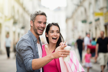 A trendy couple walking and doing shopping in the city