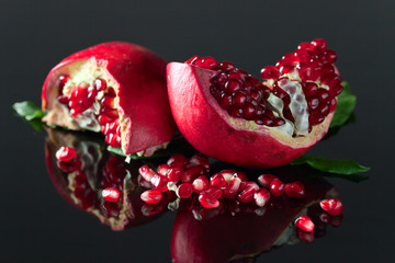 ripe pomegranate on a black table