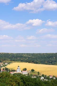 Landscape view with Capriana Monastery and the village in Moldova surrounded by forest
