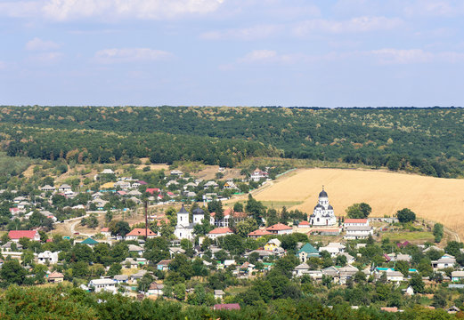 Landscape view with Capriana Monastery and the village in Moldova surrounded by forest