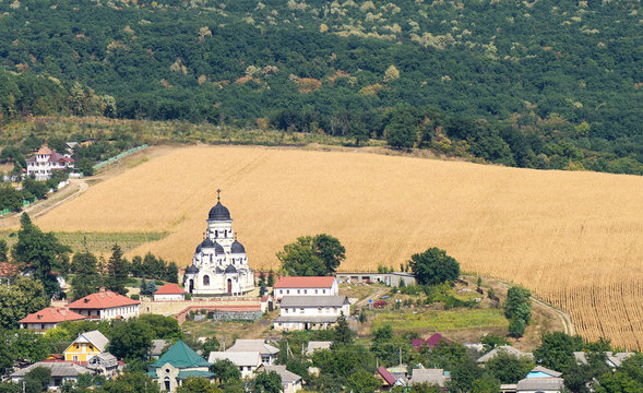 Landscape view with Capriana Monastery and the village in Moldova surrounded by forest