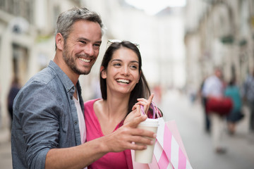A trendy couple walking and doing shopping in the streets