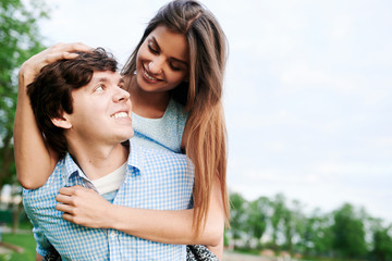 Young happy couple embracing and having fun in the summer in the city