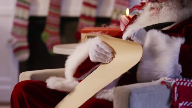Santa Claus writes on naughty and nice list