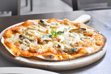 seafood pizza in the wooden  tray