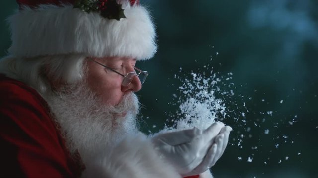 Santa Claus blowing snow from hands in slow motion, Phantom Flex 4K