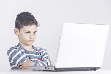 Frustrated boy in front of a laptop computer