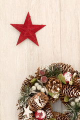 Delicate Christmas wreath of pine cones and a red star