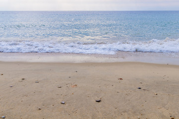 Ocean wave close and sand beach background