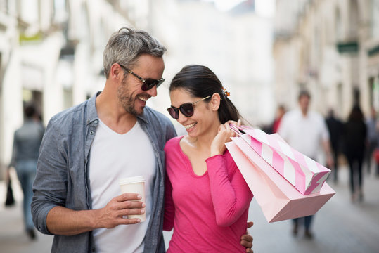 A trendy couple walking and doing shopping in the streets
