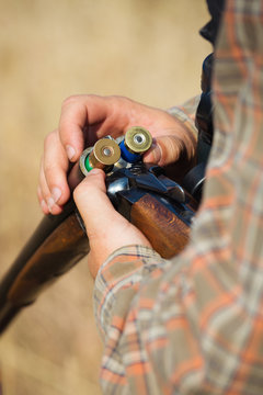 Close-up of a hunter loading his shotgun