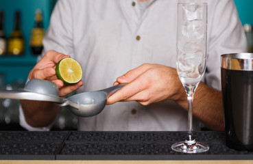 Barman's hands making cocktail with egg yolk