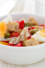 salad with fish and egg in white bowl