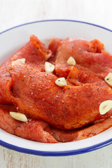 marinated meat with garlic on white dish