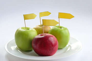 four apples with label on a plate