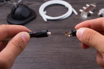 The person fixes antenna connections