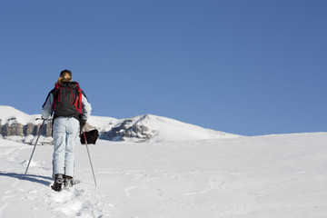 Fototapeta na wymiar woman hiking with snowshoes