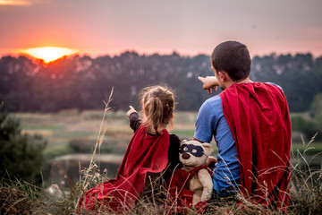 little girl with dad dressed in super heroes, happy loving family - obrazy, fototapety, plakaty