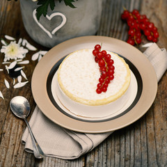 Chocolate cake with cherries on wooden background