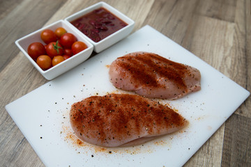 Raw chicken breast with cherry tomatoes and beans