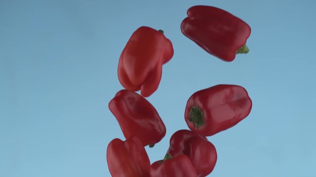 Red peppers flying in slow motion, shot with Phantom Flex 4K at 1000 frames per second