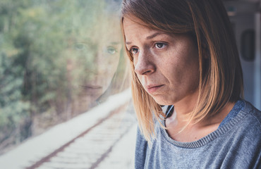 Depressed young woman in the train