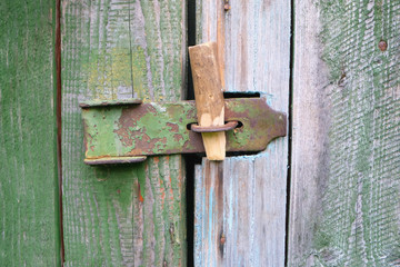 old bolt on a wooden door