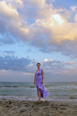 woman in a lilac dress on the beach
