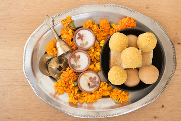 Hindu festival of lights, Dusshera and Diwali preparation and celebration ingredients- sweets, flowers, lights, cash, bell and splash cymbals and incense sticks