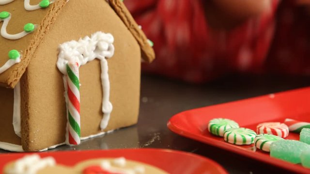 Decorating gingerbread house for Christmas
