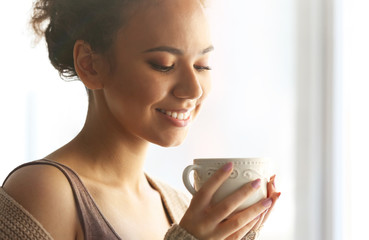 Portrait of beautiful African American girl with coffee