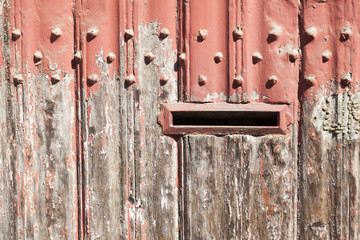 horizontal part of wooden door with old bladdered gray paint and