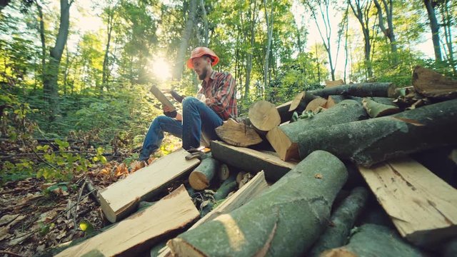 Young woodcutter work in the forest. RAW video record.